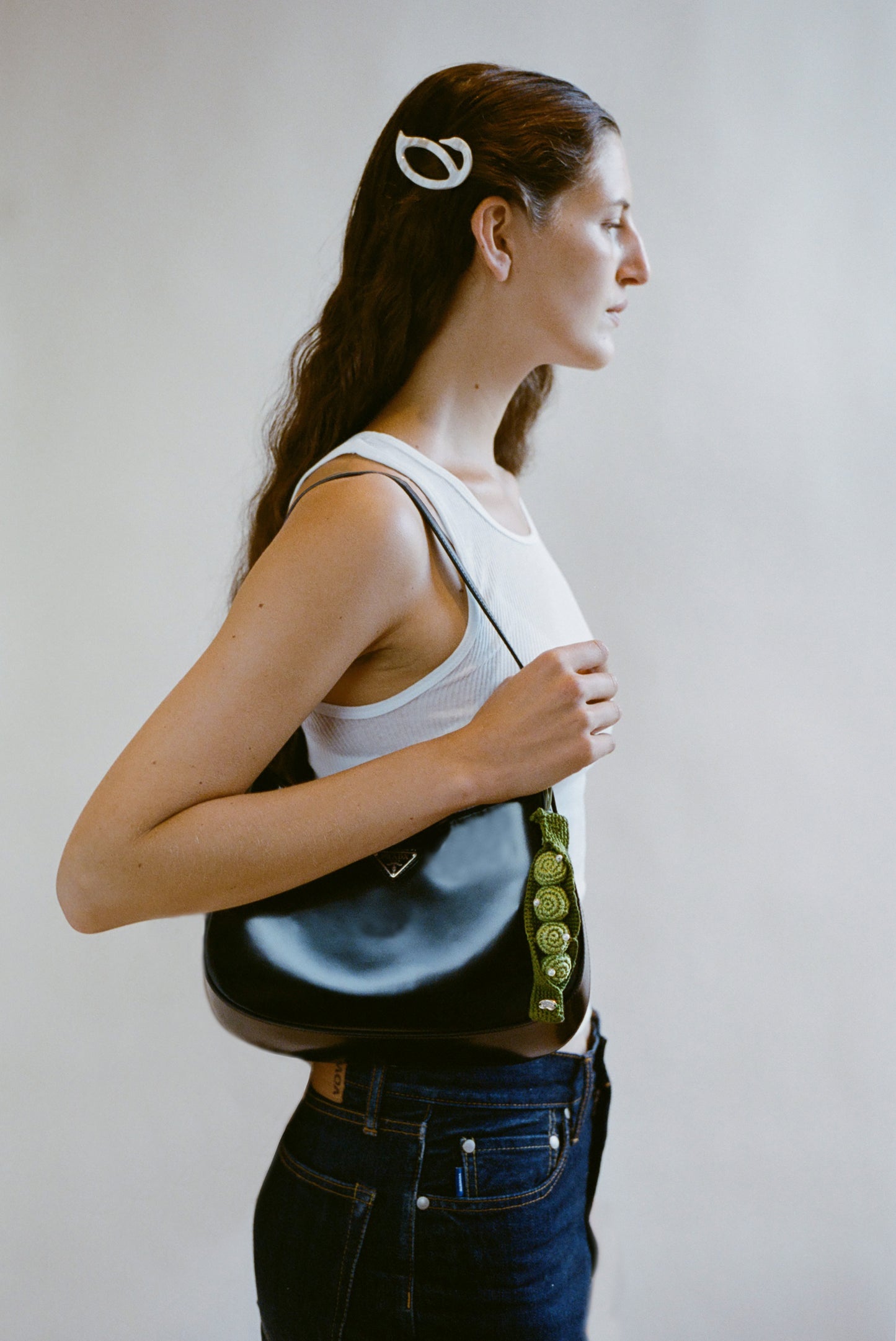 Woman holding a black handbag with a white background