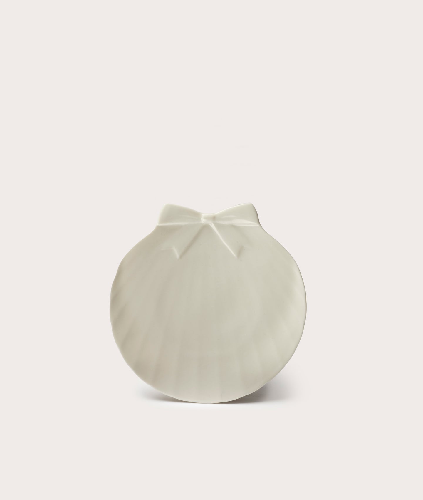 White ceramic plate with a unique design on a light gray background